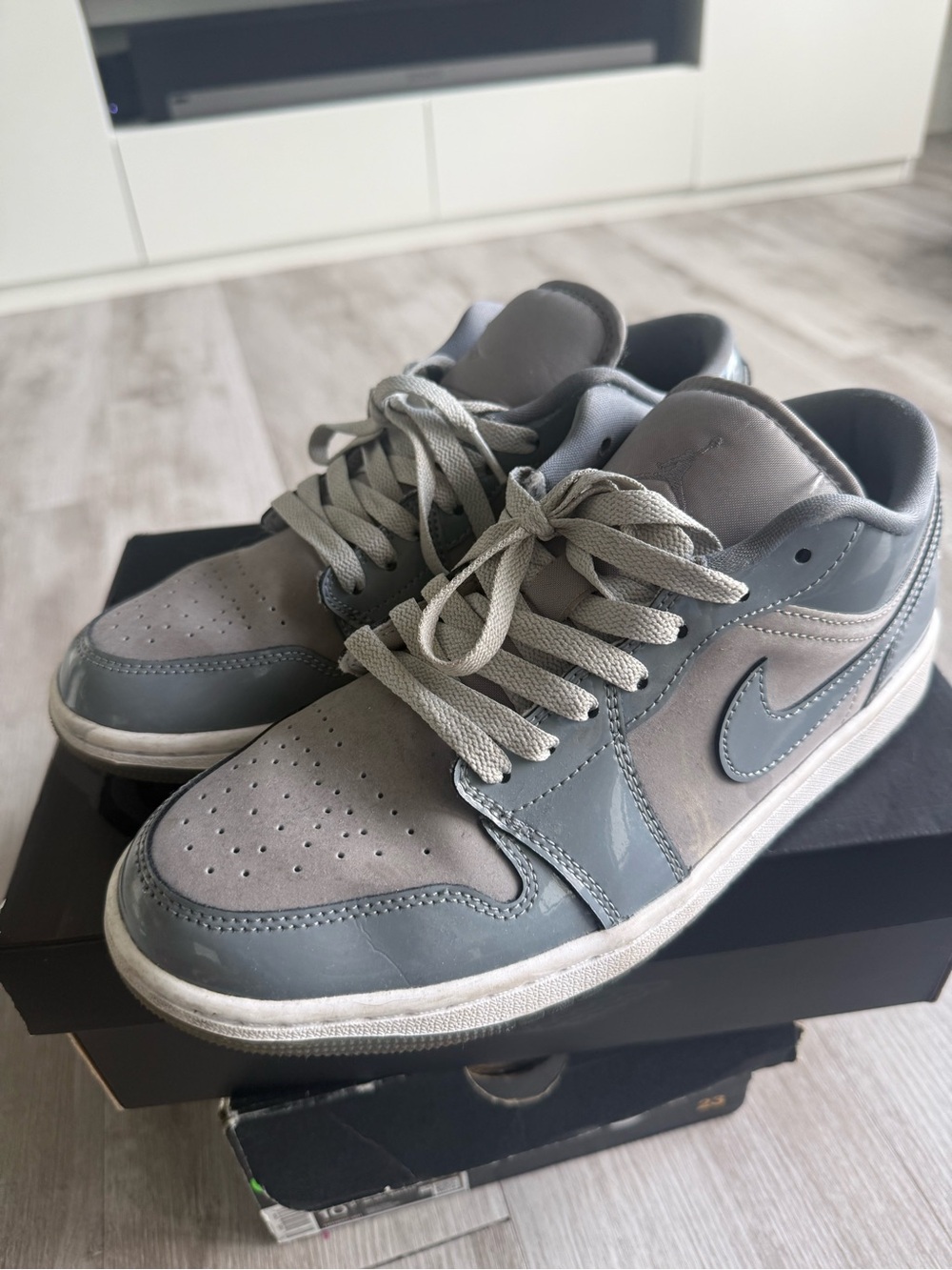 Nike Women’s Jordan 1 Low-Top Sneakers in patent Light Gray and Charcoal - 9.5